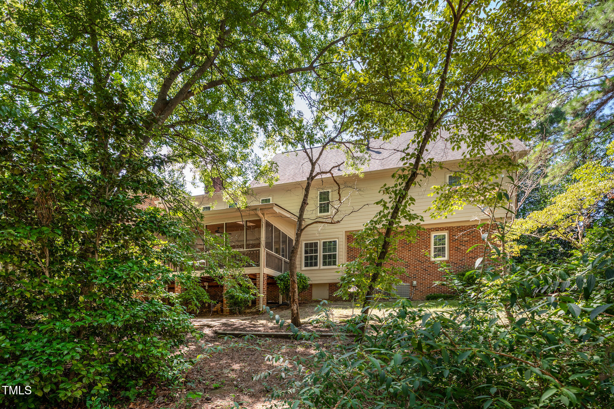 6904 Aspen Court Raleigh, NC 27615 - Photo 5 of 51 a view of a large yard with plants and large trees
