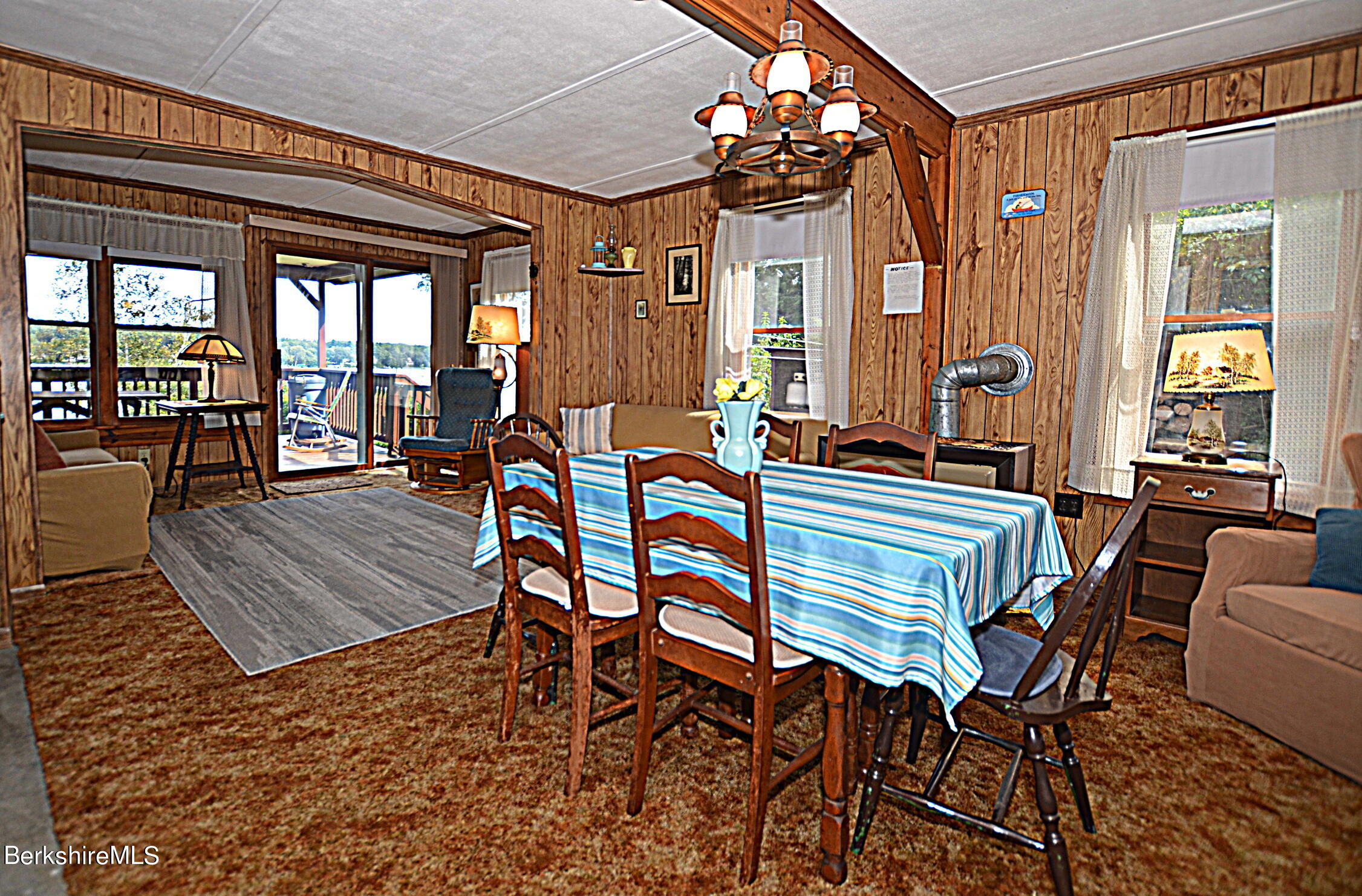 71 Flint Farm Road Otis, MA 01029 - Photo 11 of 21 a dining room with furniture wooden floor and a chandelier