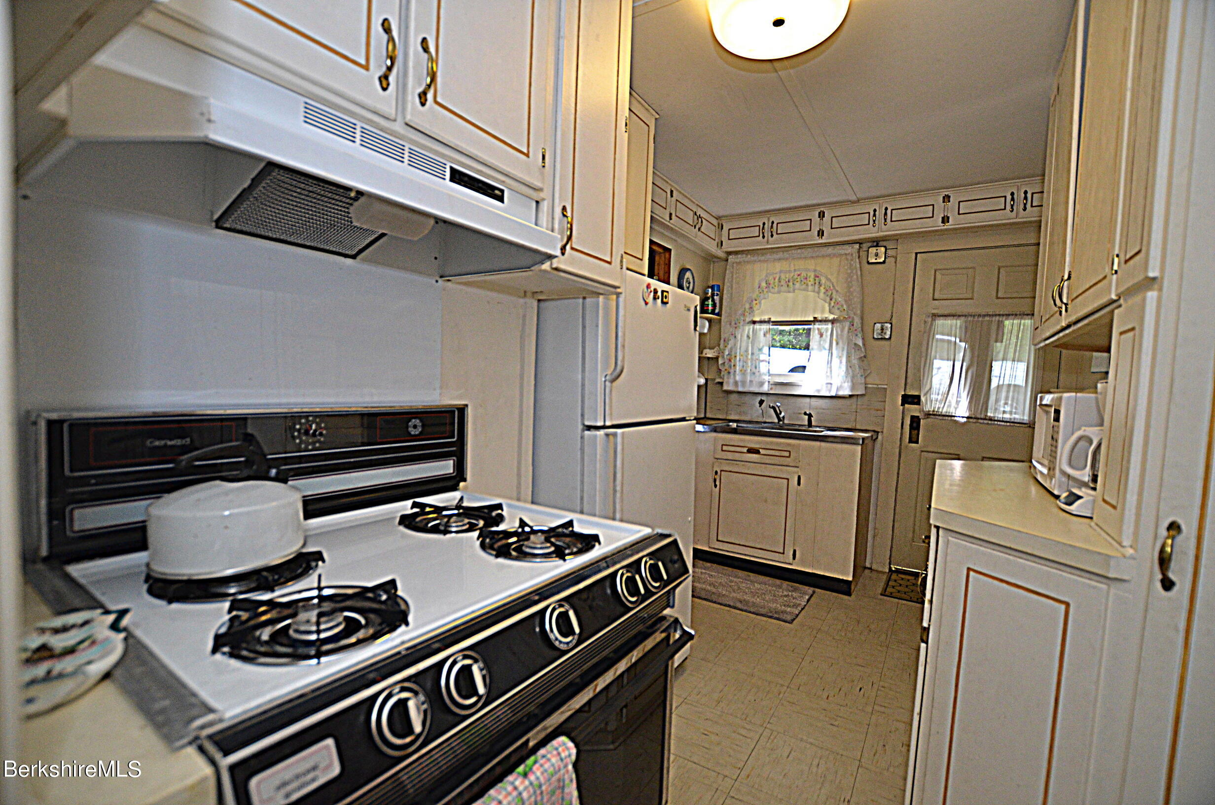 71 Flint Farm Road Otis, MA 01029 - Photo 16 of 21 a kitchen with a stove and a refrigerator