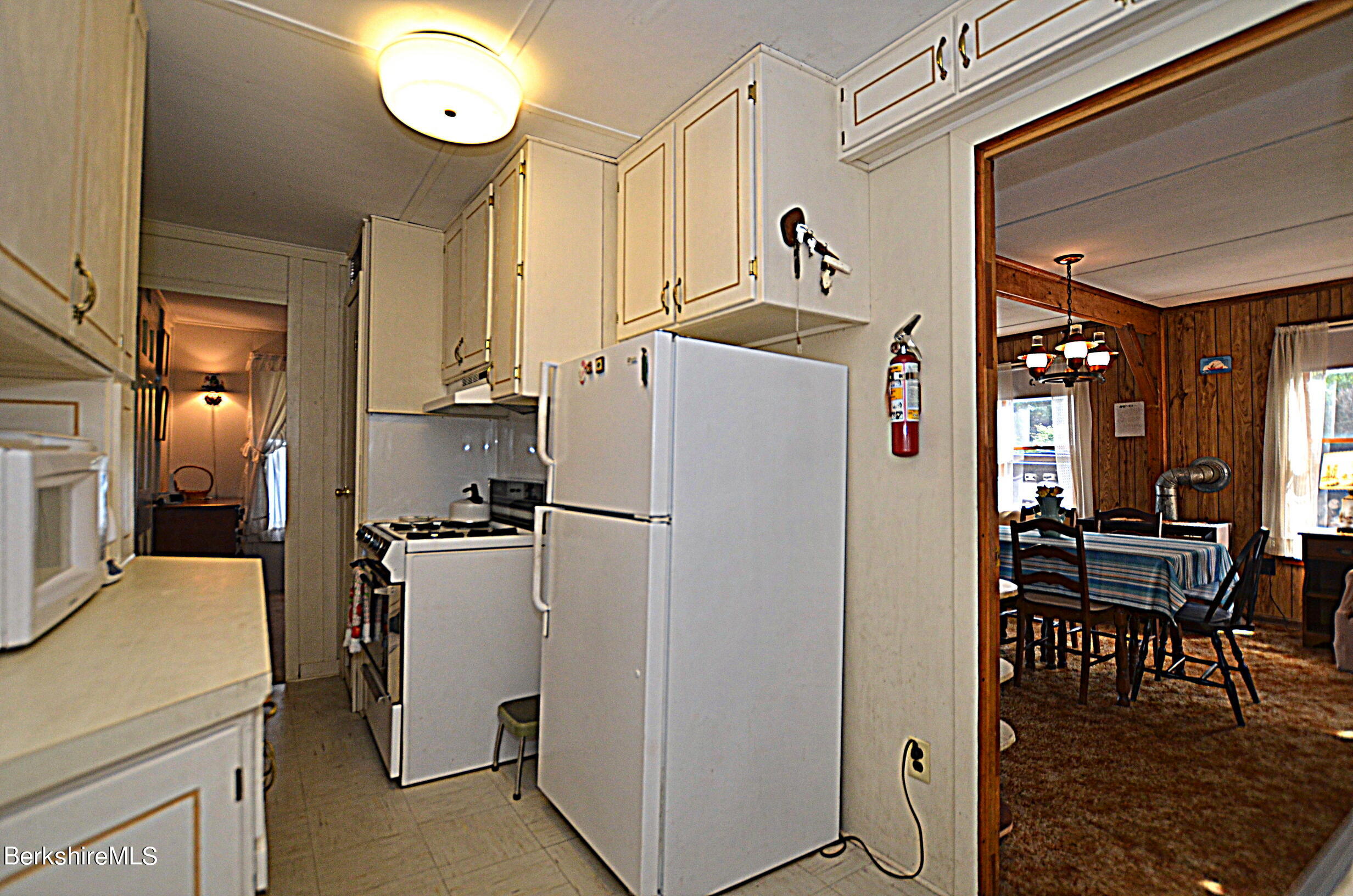 71 Flint Farm Road Otis, MA 01029 - Photo 17 of 21 a kitchen with refrigerator a table and chairs