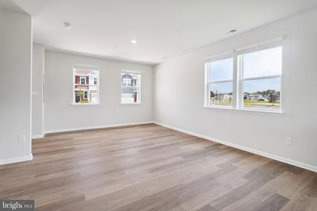 a kitchen with granite countertop a refrigerator stove microwave and sink