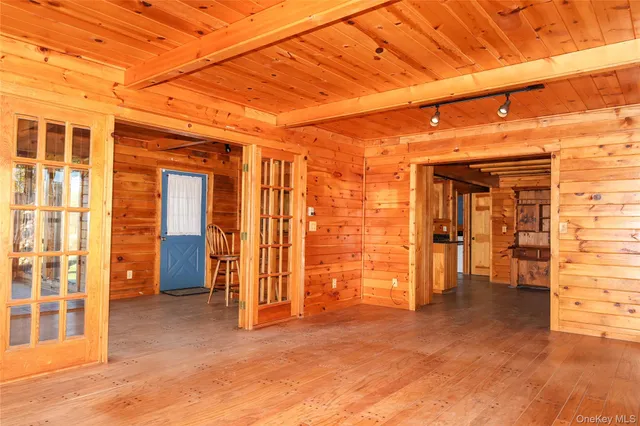 a view of empty room with wooden walls