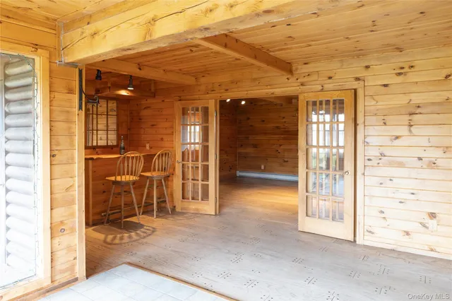 a view of a hallway with wooden walls