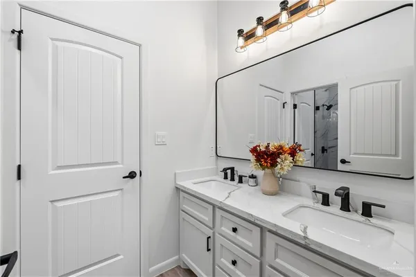 a bathroom with a double vanity sink mirror and double