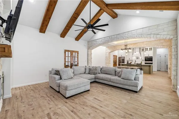 a living room with furniture and a view of kitchen