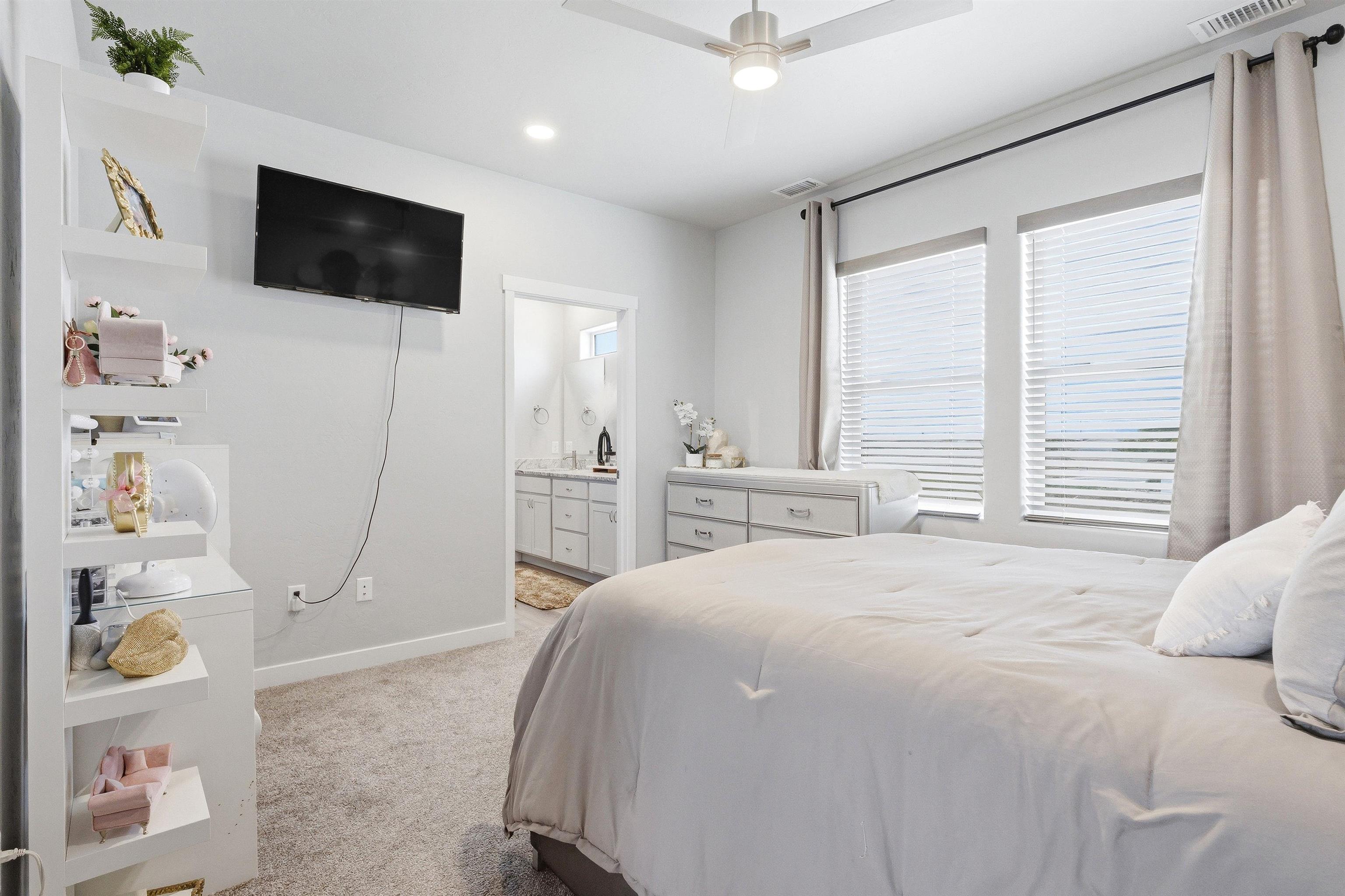 2459 Hamilton Road, Unit A Grand Junction, CO 81505 - Photo 12 of 27 a bedroom with a bed a flat screen tv and guitar