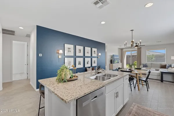 a kitchen with center island table and chairs