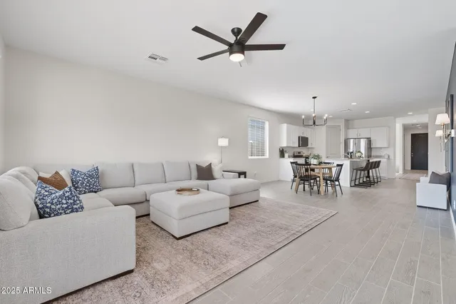 a living room with furniture and view of kitchen