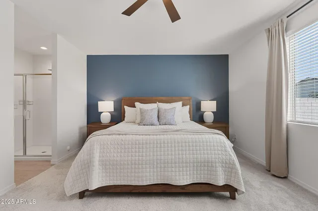 a bedroom with a bed and a night stand