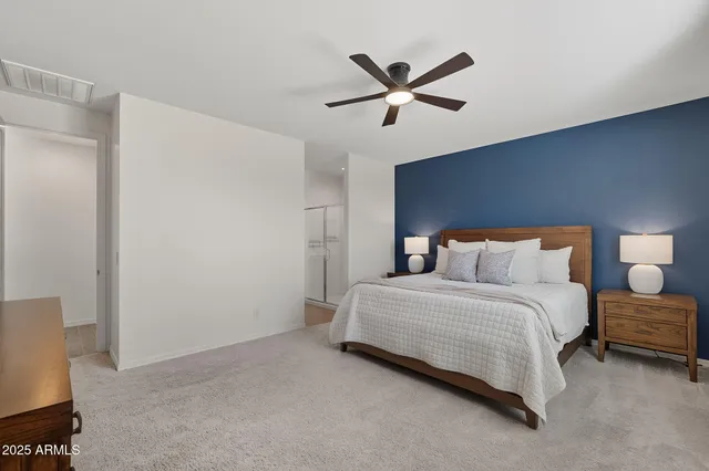 a bedroom with a bed and painting on the wall