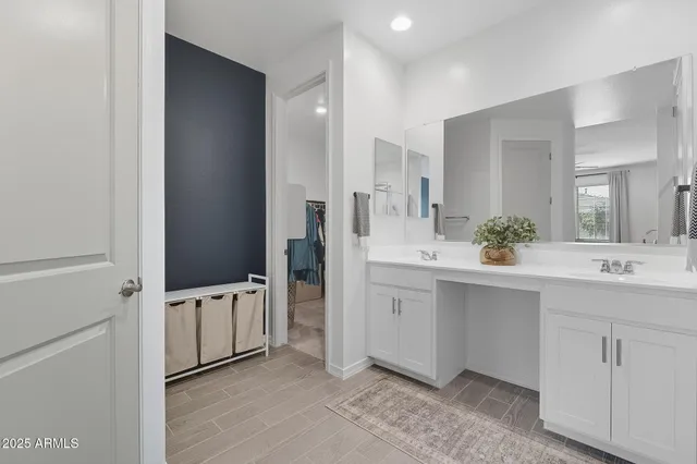 a spacious bathroom with a double vanity sink a mirror and a shower