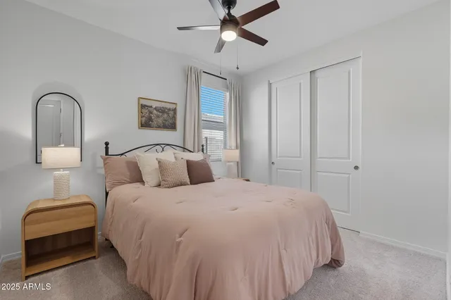 a bedroom with a bed and a lamp