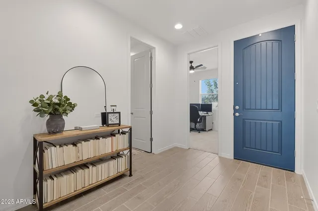 a view of a hallway to a livingroom with furniture