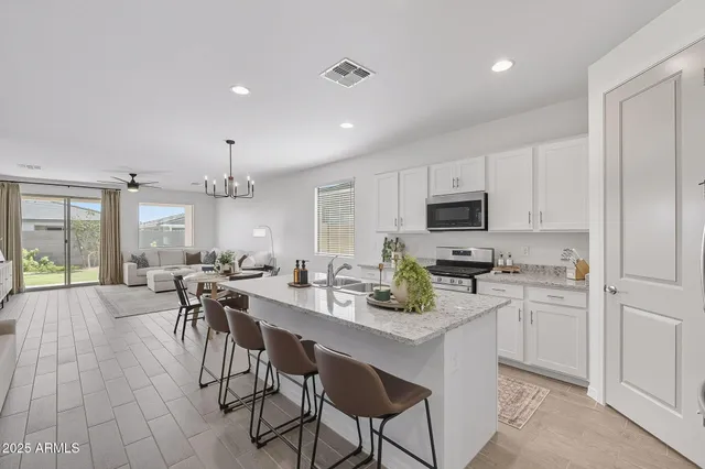 a kitchen with a table chairs microwave and cabinets