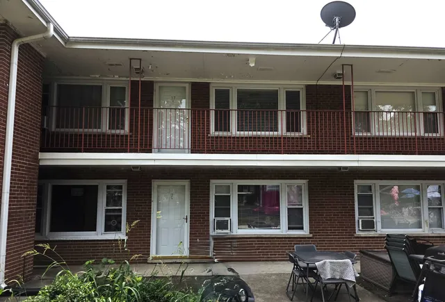 a view of a brick building with many windows