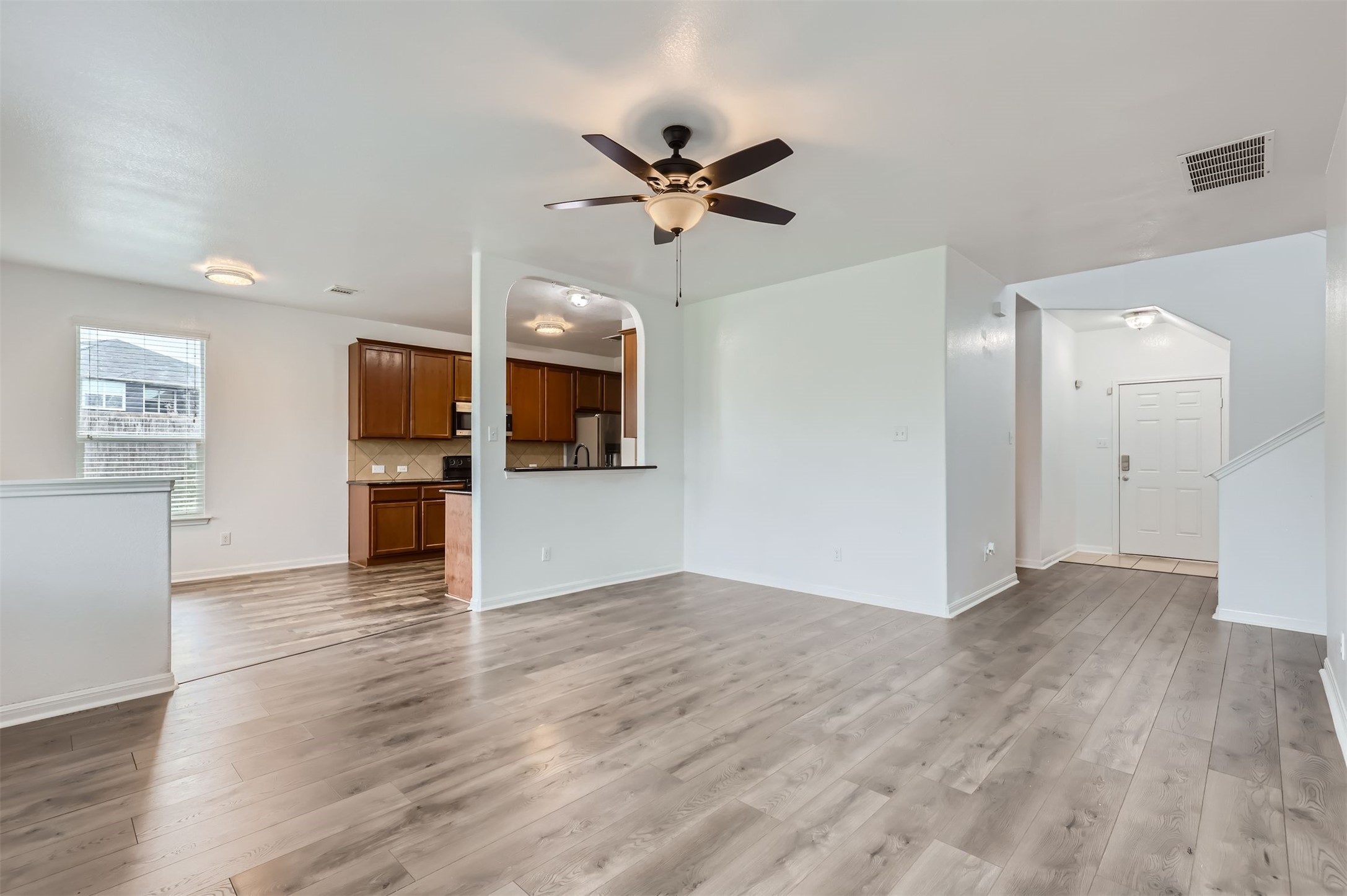 131 Lavaca Loop Hutto, TX 78634 - Photo 28 of 29 An open floor plan with wood flooring and recessed lighting offers a clean, contemporary living space.