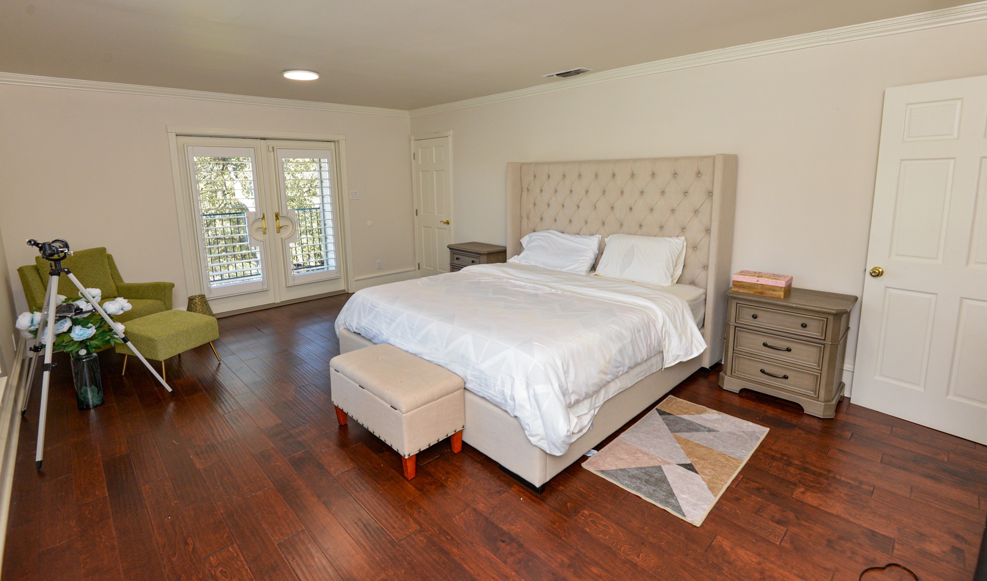 10710 D-K Ranch Road Austin, TX 78759 - Photo 17 of 34 Rich hardwood floors complement this light-filled primary bedroom with private balcony access.