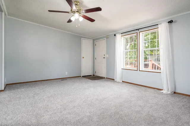 a view of an empty room with a window