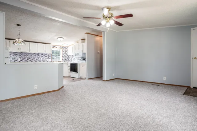 a view of a kitchen with a sink and a refrigerator