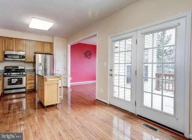 a view of kitchen with furniture wooden floor and window