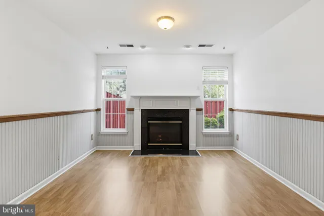 a view of a livingroom with a fireplace and a window