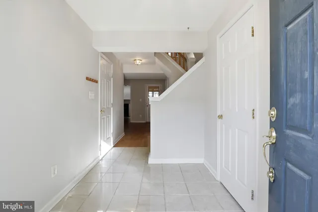 a view of hallway with stairs and a chandelier