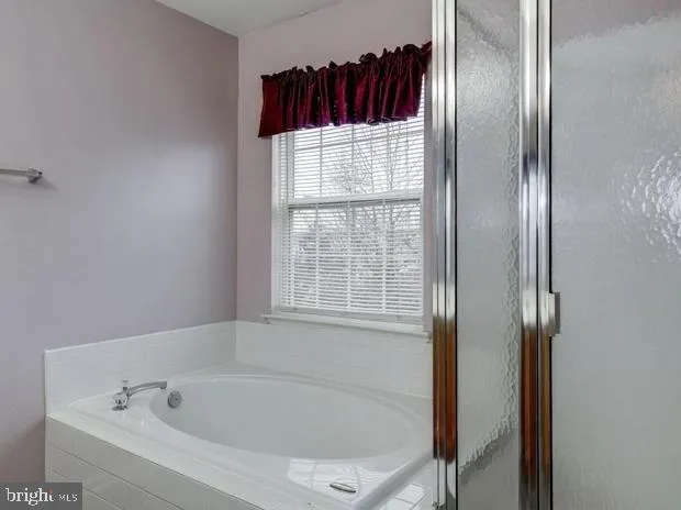 a white bath tub sitting next to a window