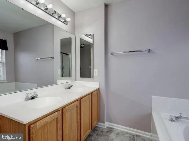 a bathroom with a sink vanity and a mirror