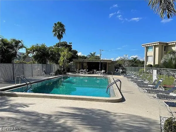 a swimming pool with outdoor seating and yard