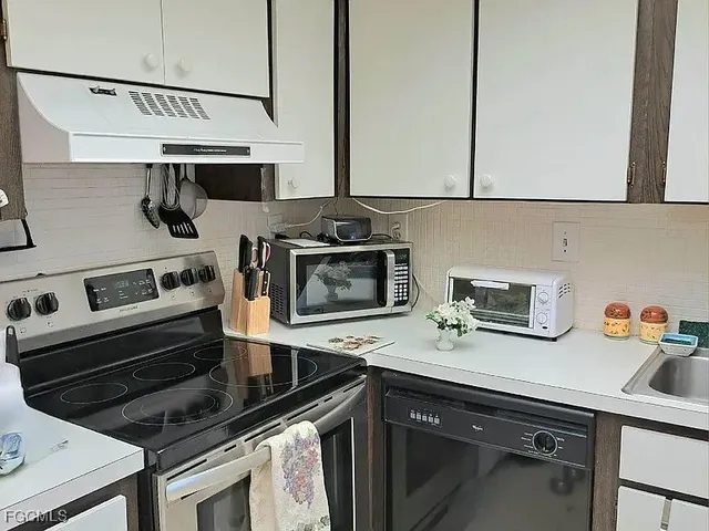 a kitchen with appliances cabinets and a sink