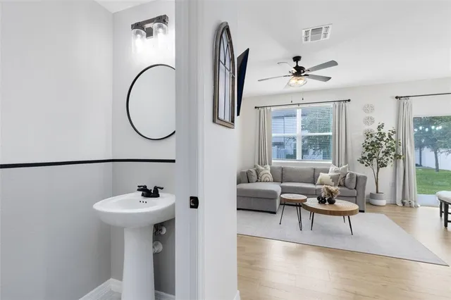 a living room with furniture a window and a chandelier