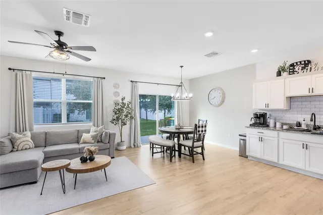 a living room with furniture a wooden floor and a window