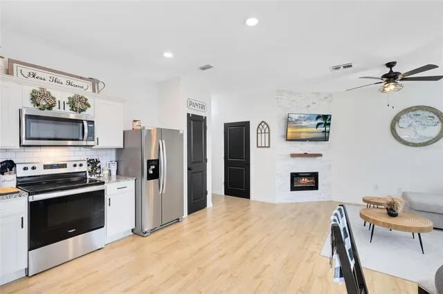 a kitchen with stainless steel appliances a stove a refrigerator and a refrigerator
