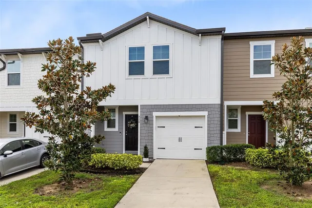 a front view of a house with a yard and garage