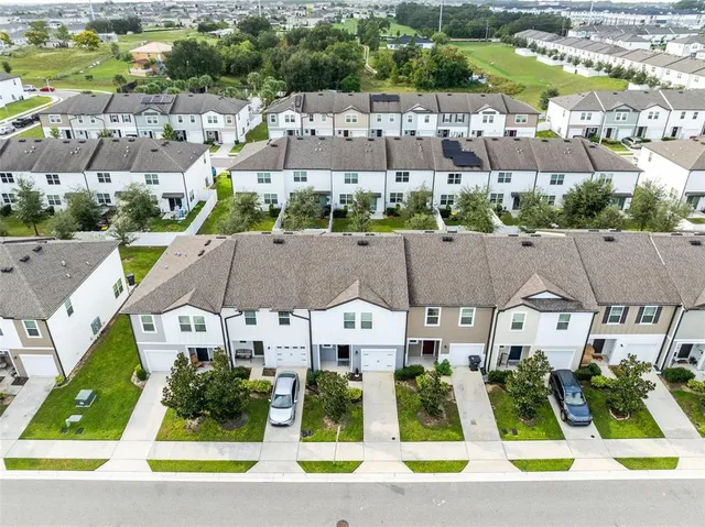 an aerial view of houses with yard