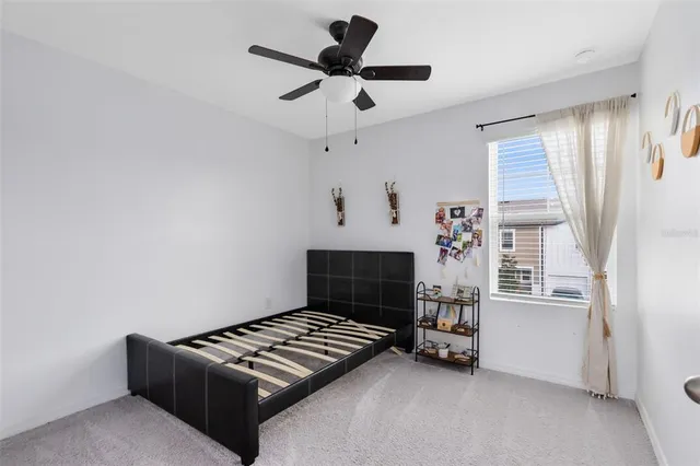 a bedroom with bed and a window