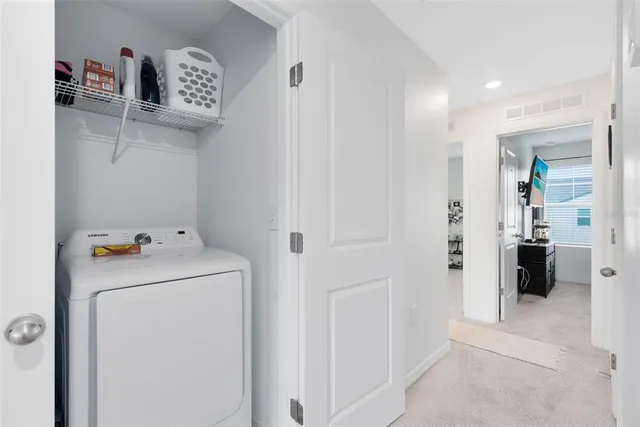 a view of storage and utility room with washer and dryer