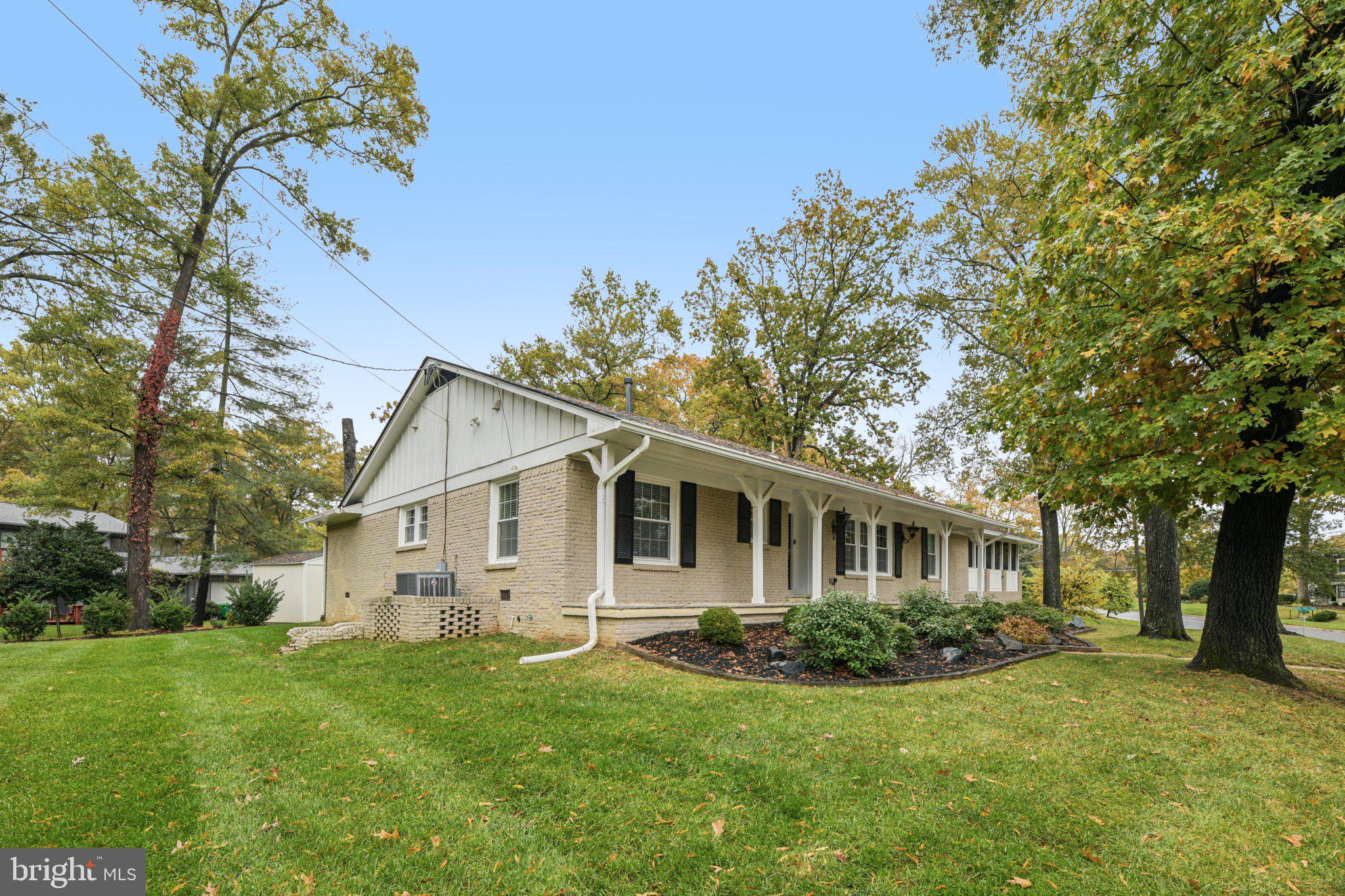 12301 Arrow Park Drive Fort Washington, MD 20744 - Photo 5 of 10 a view of a yard in front of a house with plants and large tree