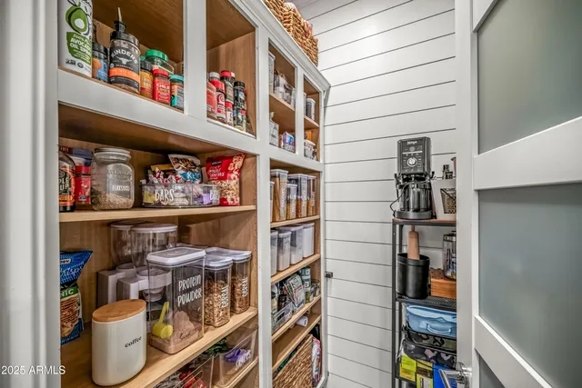 a view of a hallway with a bedroom and a window