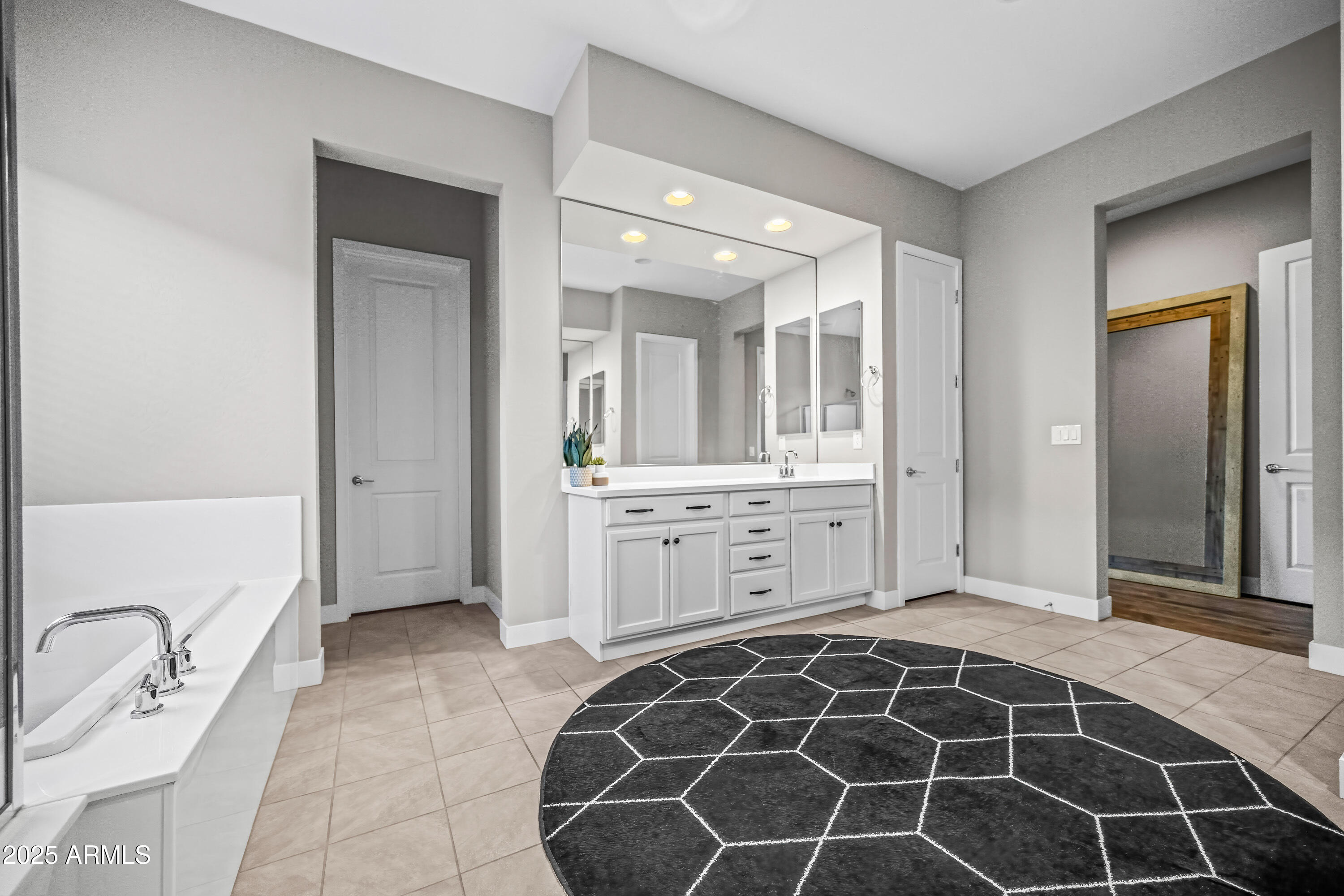 22211 North 31st Street Phoenix, AZ 85050 - Photo 23 of 94 an empty room with a mirror and a sink