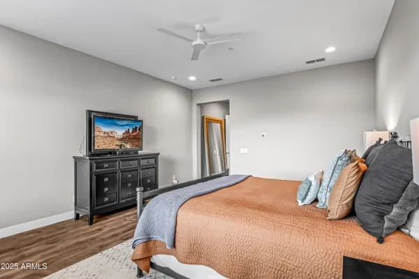 a bedroom with a bed chair and a window