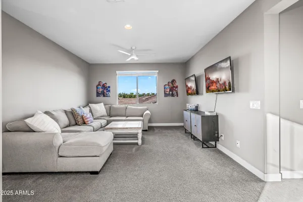 a living room with furniture kitchen view and a large window
