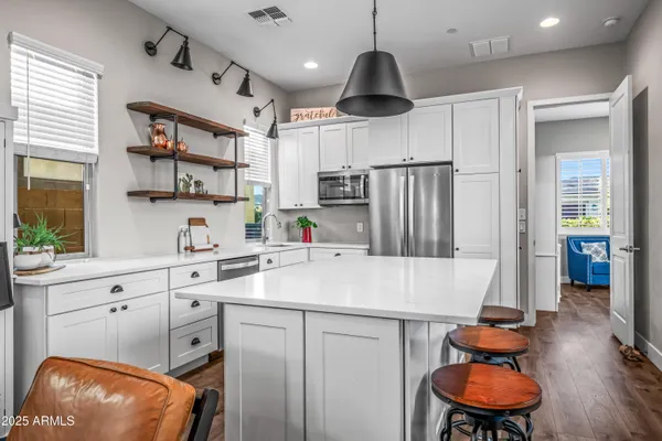 a living room with furniture a wooden floor and next to a window