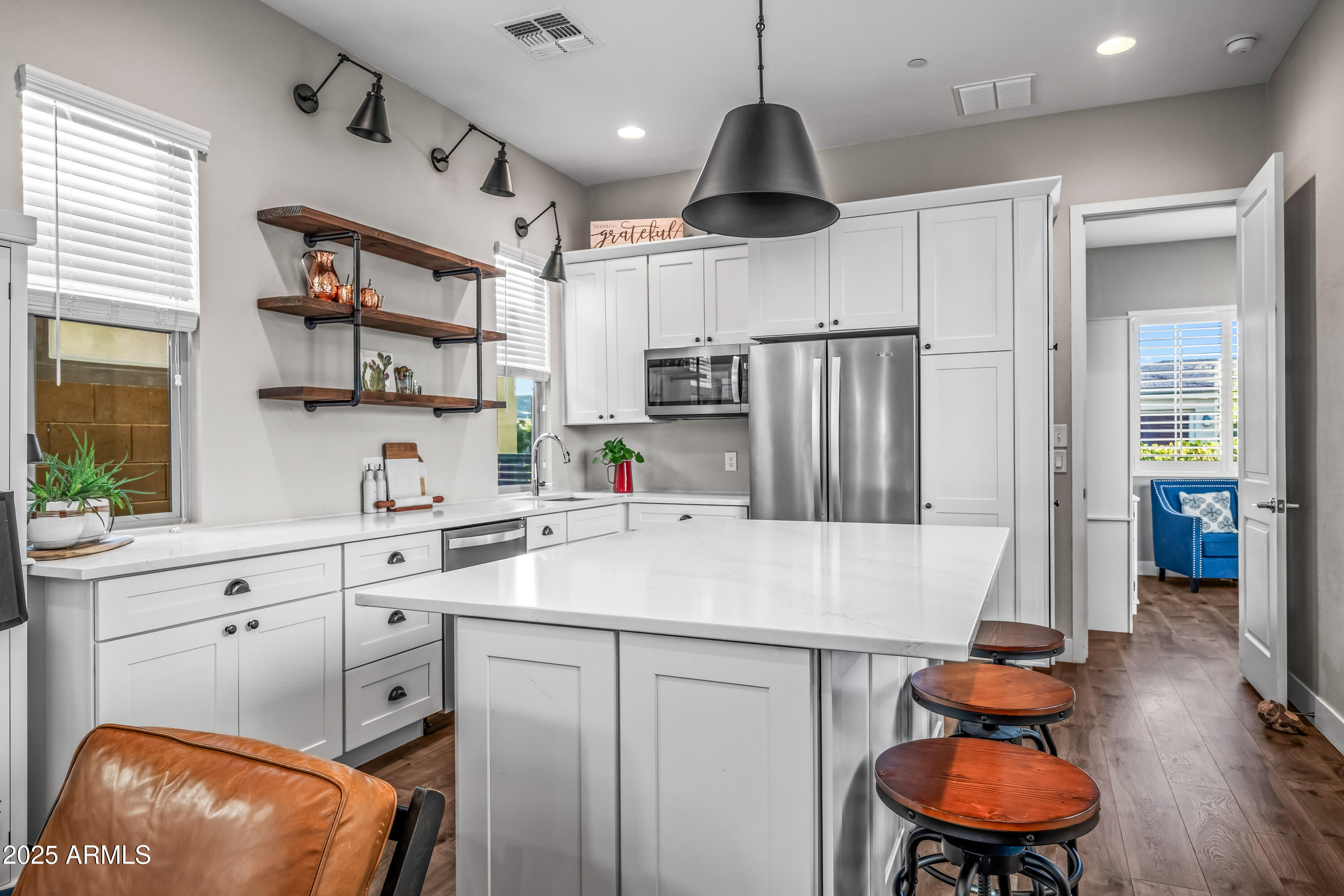 22211 North 31st Street Phoenix, AZ 85050 - Photo 47 of 94 a kitchen with stainless steel appliances granite countertop a sink a refrigerator and a stove