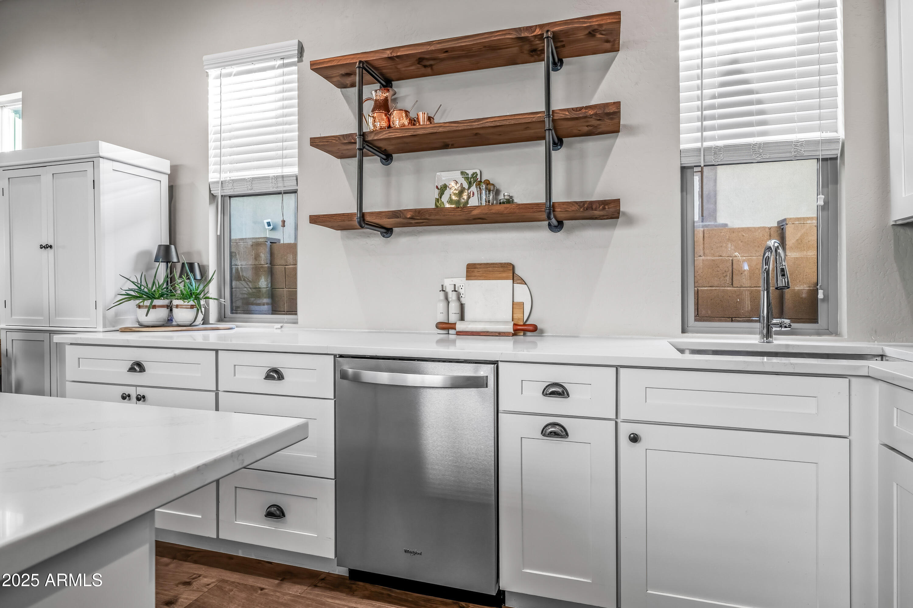 22211 North 31st Street Phoenix, AZ 85050 - Photo 48 of 94 a kitchen with stainless steel appliances cabinets a window and wooden floor