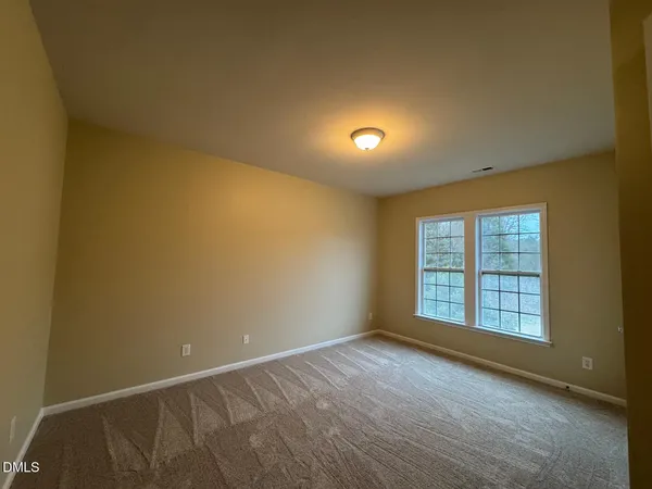 an empty room with a empty space and windows