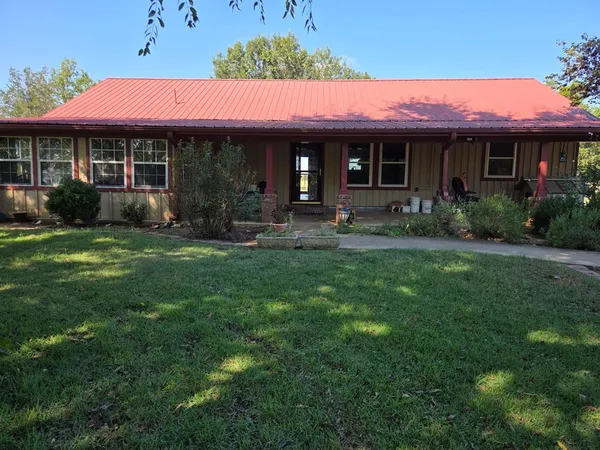 a front view of a house with a yard table and chairs
