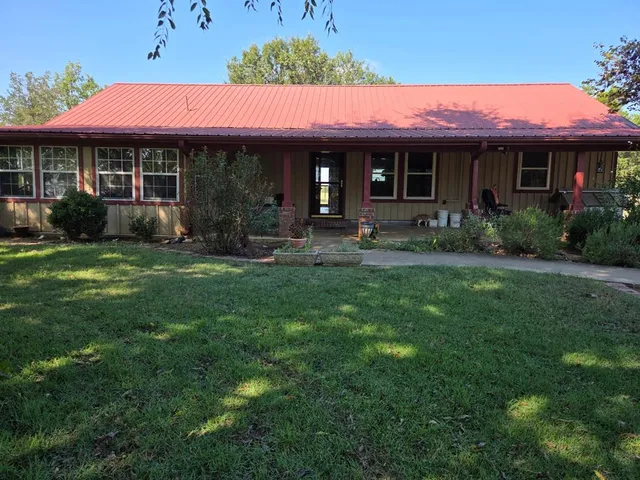 a front view of a house with a yard table and chairs