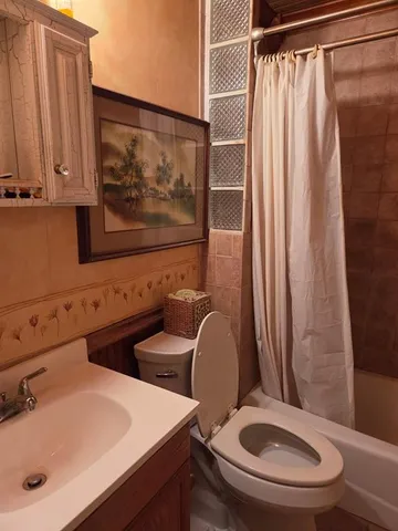 a bathroom with a toilet a sink and a mirror