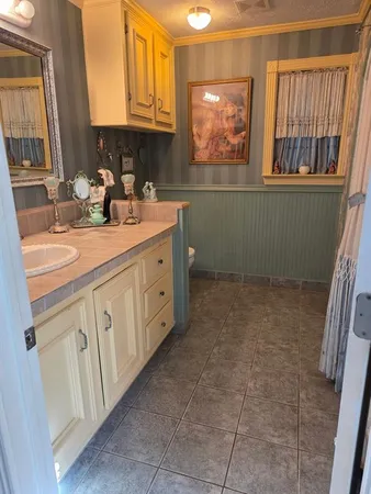 a bathroom with a black and white checkered floor